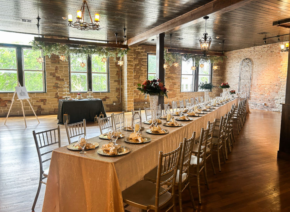 Round reception table with a tall crystal vase floral centerpiece